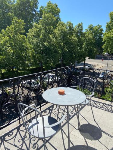 a white table and chairs on a balcony at Le Relais de l'Orangerie in Strasbourg