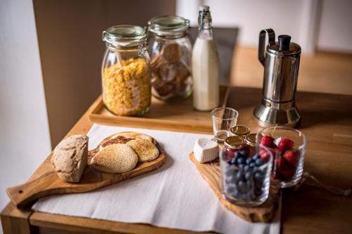 a table with bread and other food items on it at B&B Sopralapanca in Postalesio