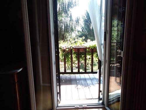 an open door with a view of a patio at B&B La Capanna Rossa in San Romolo