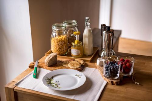 a wooden table with a plate and some food on it at B&B Sopralapanca in Postalesio