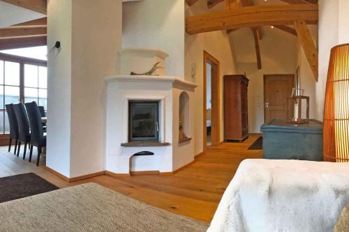 a living room with a fireplace in a house at Hotel Penzinghof in Oberndorf in Tirol