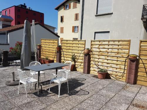 a table and chairs sitting next to a fence at Bottega del Vino Guesthouse in Locarno