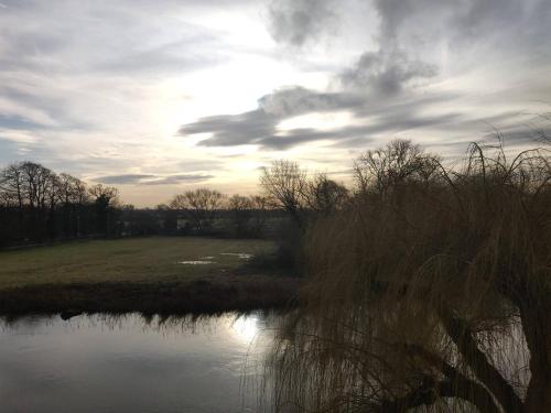 a view of a river with a cloudy sky at River Penthouse Little Paxton - 75 Skipper Way in Saint Neots