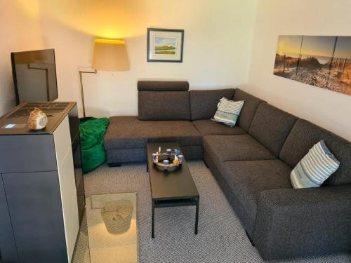 a living room with a couch and a table at Haus Charenza in Garz-Rügen
