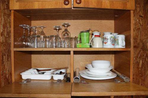 a cabinet filled with dishes and other kitchen items at Sadyba Lukacha in Zhdenievo