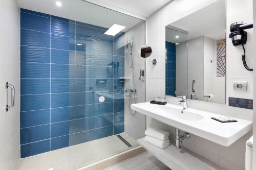 a bathroom with a shower, sink, and tub at Riu Vistamar Gran Canaria - All Inclusive in Puerto Rico de Gran Canaria