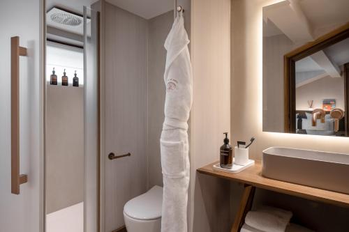 a bathroom with a white towel hanging above a sink at Coeur de Megève in Megève