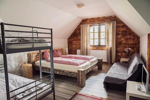 sypialnia z 2 łóżkami piętrowymi i oknem w obiekcie Gazdovský dvor B&B s Mini Wellness w Beszeniowej