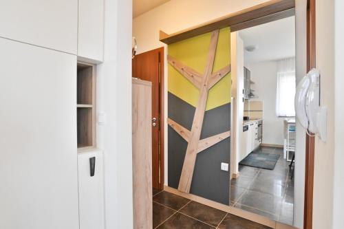 a kitchen with a sliding glass door with a tree mural at The View Zlatibor Hills in Zlatibor