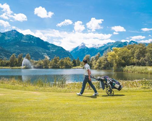 a man walking a stroller with a baby carriage at Pension Patricia - Summercard included from may 15th in Kaprun