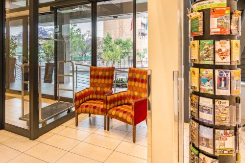 two chairs in front of a store at City Lodge Hotel Hatfield, Pretoria in Pretoria