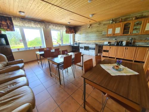 a kitchen and dining room with tables and a couch at Gabriel in Maardu