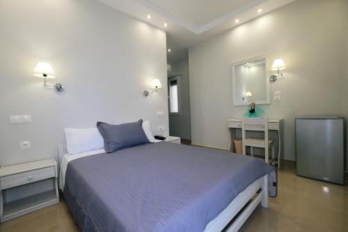 a bedroom with a large bed and two tables at Limnia Gi in Mirina
