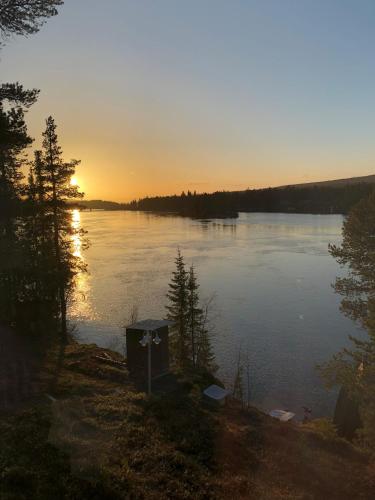 a view of a body of water with the sun setting at Hotel E-10 by First in Kiruna