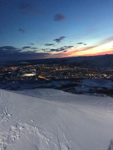 a view of a city in the snow at sunset at Hotel E-10 by First in Kiruna