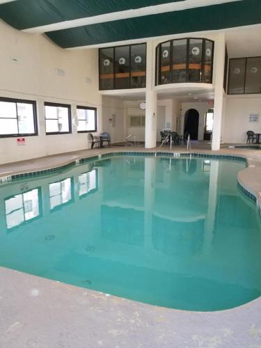 a large swimming pool with blue water in a building at Ocean Dream Vacation in Myrtle Beach