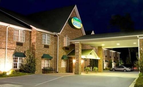 a hotel with a car parked in front of it at Mountain Inn & Suites Flat Rock in Flat Rock