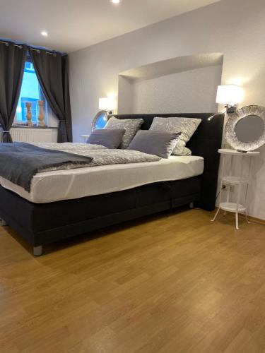 a bedroom with a large bed with a large headboard at Ferien am Schlössle in Ochsenfurt