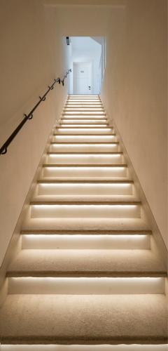 a stairway with a white door and some stairs at San Michele Relais & Spa in Sirolo