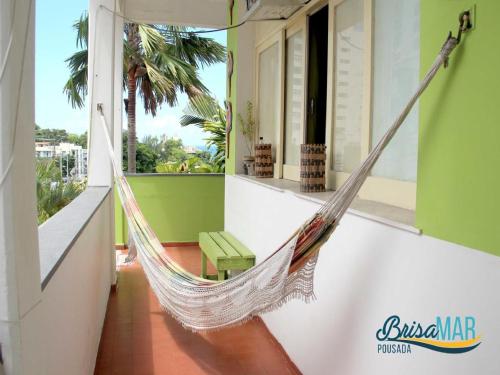 a hammock hanging on the side of a building at Hotel Pousada Brisa Mar in Salvador