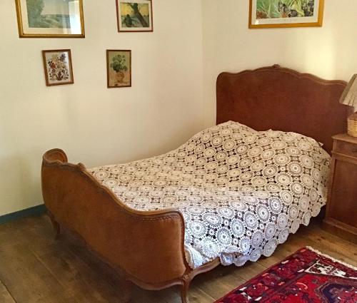a bedroom with a bed with a comforter on it at Orfenor in Brioude