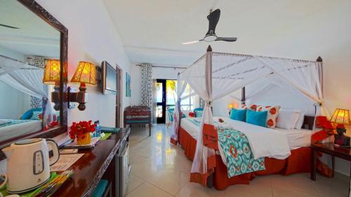 a bedroom with two beds and a mirror at Papillon Lagoon Reef Hotel in Diani Beach