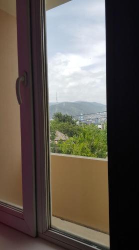 a window with a view of a city at Guesthouse different in Tbilisi City