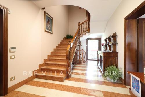 a staircase in a home with wooden floors at B&B Villa Verona Bike in Buttapietra