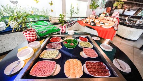 a table with a tray of different types of food at Papillon Lagoon Reef Hotel in Diani Beach