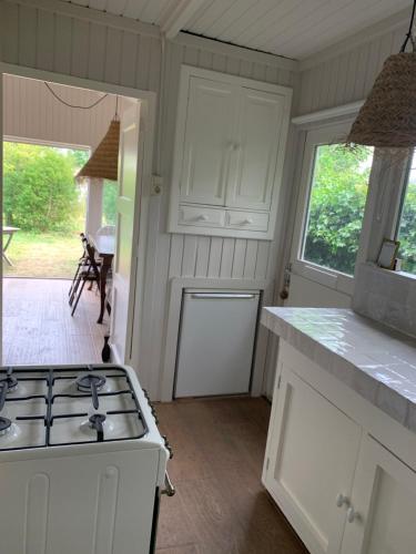 a kitchen with a stove and a counter top at Het Schulpje in Egmond-Binnen