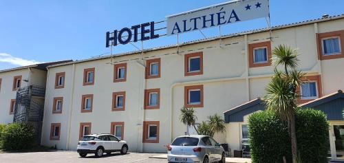 a hotel alfa with two cars parked in front of it at Hôtel Althea - Piscine et Sauna in Béziers