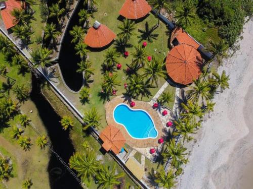 an overhead view of a resort with umbrellas and a swimming pool at Pousada E Restaurante Doce Desejo in Ilhéus