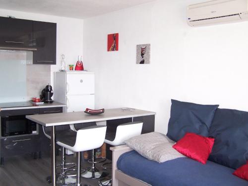 un salon avec un canapé bleu et une table dans l'établissement MARINA LE BARCARES, au Barcarès