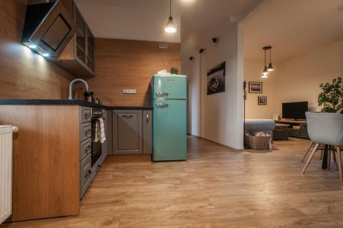 a kitchen with a green refrigerator in a room at STING Boutique Apartments in Ostrava