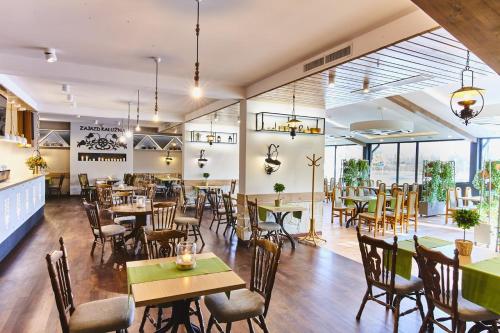 a dining room with tables and chairs in a restaurant at Zajazd Kałużna in Łącko