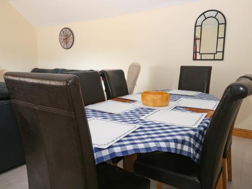 a dining room table with a blue and white checked table cloth at Daisy Nook in Hull