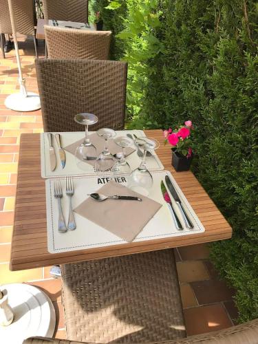 a table with a plate with utensils on it at Le Cheval Blanc in Jargeau