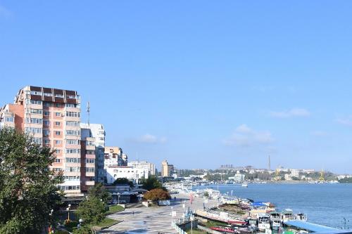 a view of a city with a river and buildings at Hotel Delta 3 in Tulcea