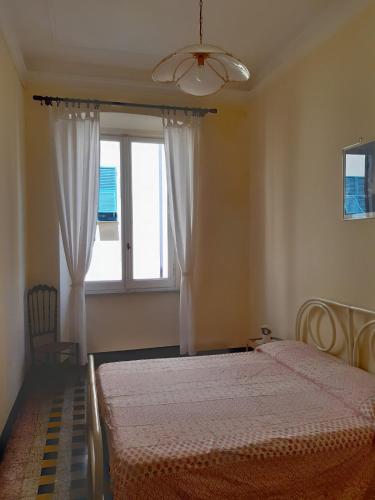 a bedroom with two beds and a window at Residenza dell'Orto in Chiavari