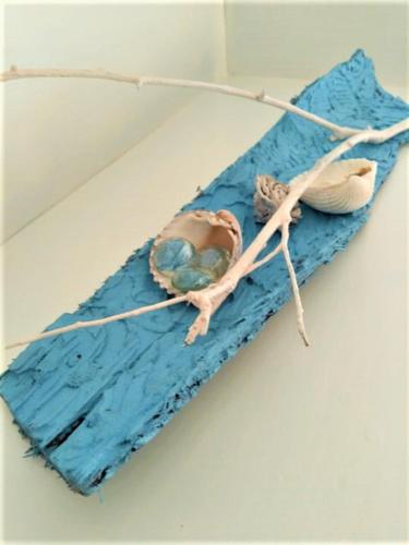 a cake on top of a blue table with two objects at Florenza Residence in Sperlonga