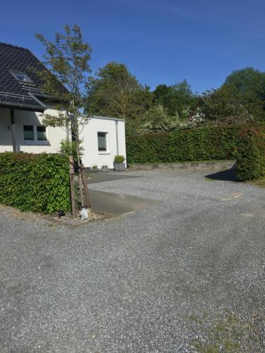 a house with a tree in the middle of a driveway at MONzeit in Monschau