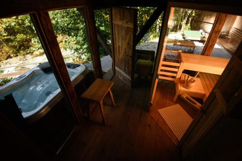 a view of a room with a tub and a table at House of Hütter - Wachtelhof & SPA in Maria Alm am Steinernen Meer