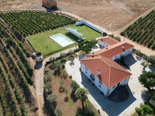 an aerial view of a house with a swimming pool at Quinta Sta Luzia Carrascal in Vila Flor