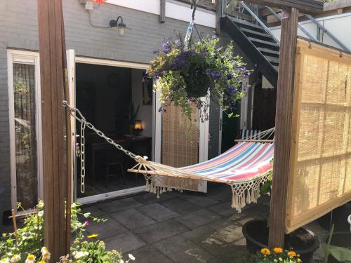 a hammock hanging on the side of a patio at SOEPP hotel & restaurant in Alkmaar