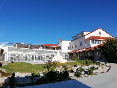 a large white building with a garden in front of it at 9Arches in Vila Nova de Poiares