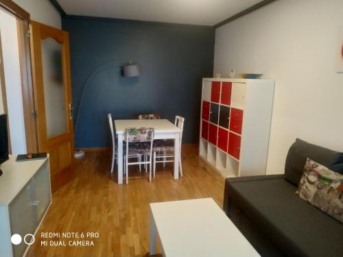 a small living room with a table and a couch at Apartamento DH in Zamora