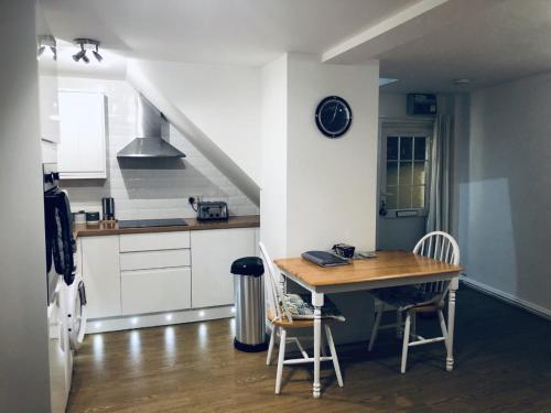 a kitchen with a table and chairs in a room at The Cottage in Redruth