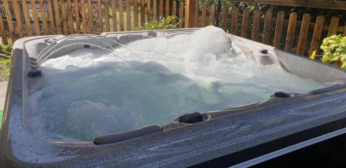 a hot tub filled with snow in a yard at La caz' à Chisy in Cilaos