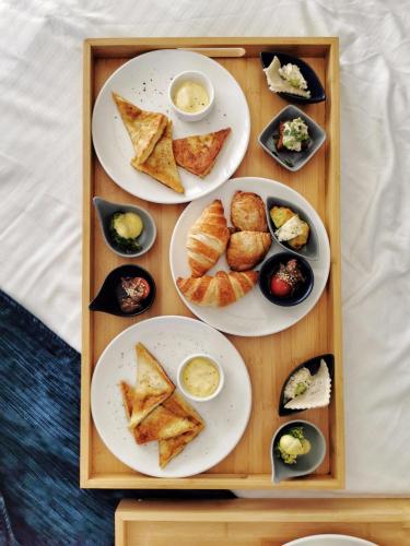 a tray with three plates of food on a table at The Duke Boutique Hotel in Victoria