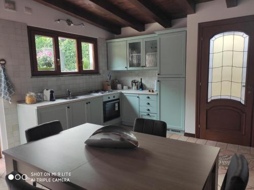 a kitchen with a table with a computer mouse on it at Secret Garden Mandello in Mandello del Lario